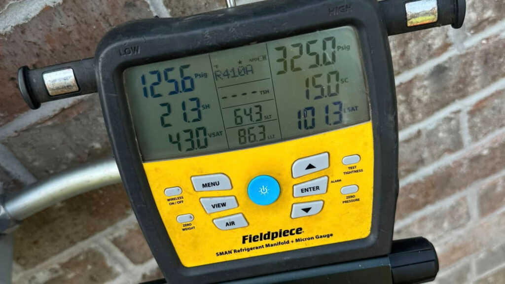 Fieldpiece SMAN Refrigerant Manifold and Micron Gauge displaying R-410A readings: low side 125.6 Psig, high side 325.0 Psig
