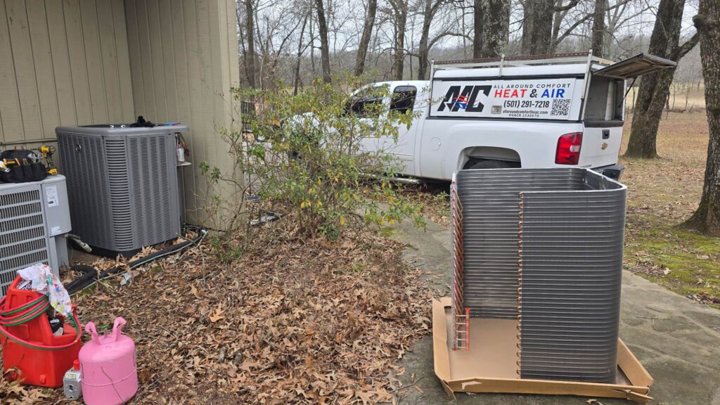 All Around Comfort Heat & Air technician truck parked beside a building during an outdoor AC unit installation or replacement